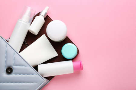 Bag with set of cosmetic products on color background