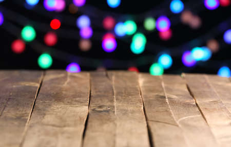 Closeup view of table against blurred lightsの写真素材