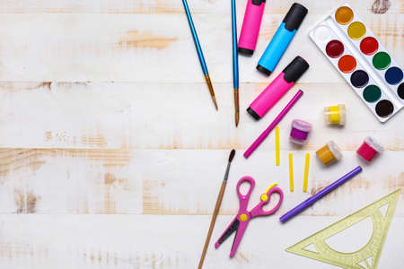 Set of school supplies on white wooden background