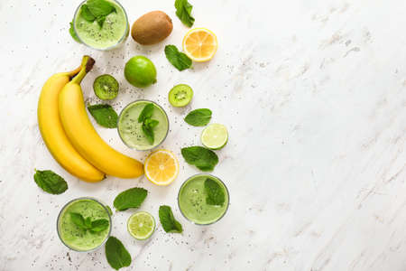 Composition with glasses of healthy fruit smoothie on tableの写真素材