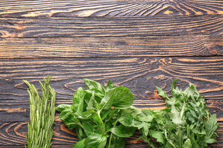 Different fresh herbs on wooden backgroundの写真素材