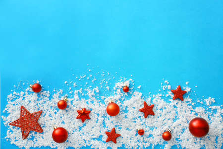 Beautiful Christmas composition with snow and decor on color backgroundの写真素材