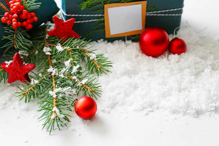 Beautiful Christmas decor, gifts and fir branches on snowの写真素材