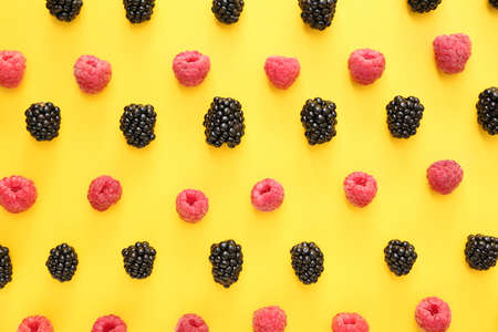 Ripe blackberry and raspberry on color background