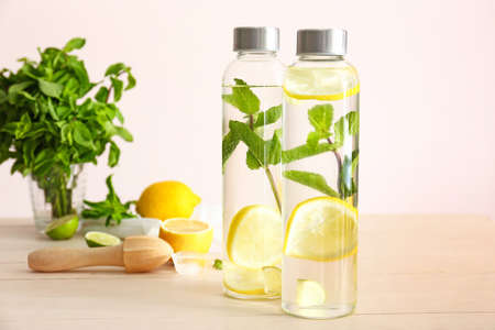 Bottles of fresh infused water on table