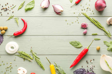 Frame made of fresh herbs with vegetables and spices on wooden backgroundの写真素材