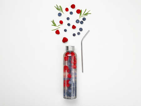 Bottle of fresh infused water and ingredients on white backgroundの写真素材