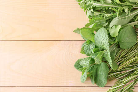 Different fresh herbs on wooden tableの写真素材