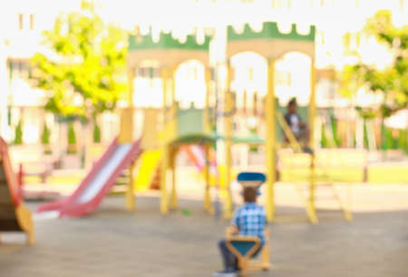 Cute little children on playground, blurred viewの写真素材