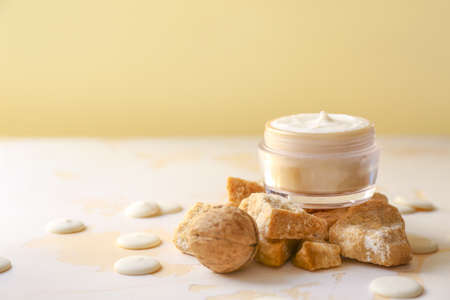 Jar of natural cream and lump brown sugar on tableの写真素材