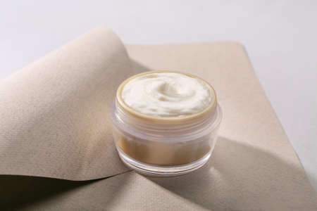 Jar of natural cream on light background