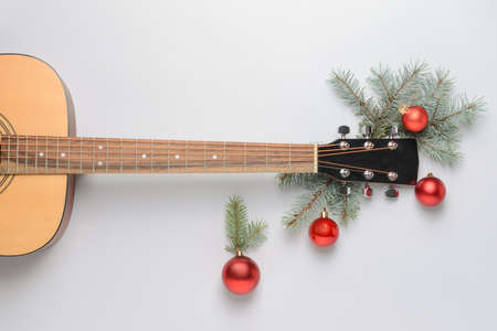 Guitar and Christmas decor on light backgroundの写真素材