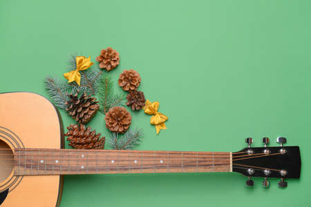 Guitar and Christmas decor on color backgroundの写真素材