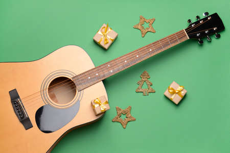 Guitar and Christmas decor on color backgroundの写真素材