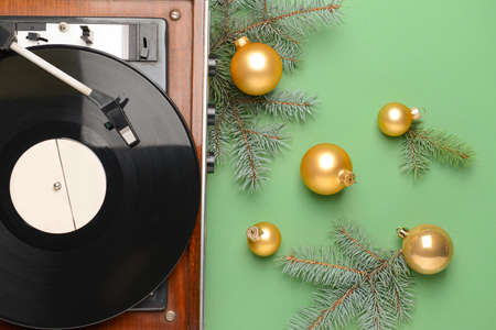 Record player and Christmas decor on color backgroundの写真素材