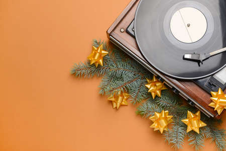 Record player and Christmas decor on color backgroundの写真素材