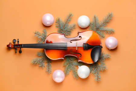 Violin and Christmas decor on color backgroundの写真素材