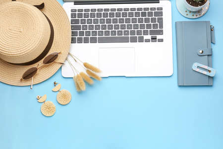 Laptop with female accessories and wallet on color background