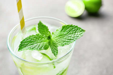 Glass of fresh mojito on table, closeup