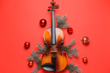 Violin and Christmas decor on color backgroundの写真素材