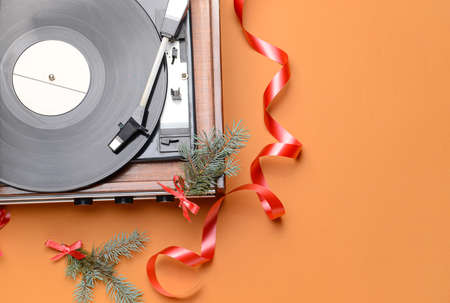 Record player and Christmas decor on color backgroundの写真素材