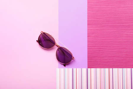 Stylish sunglasses on color backgroundの写真素材