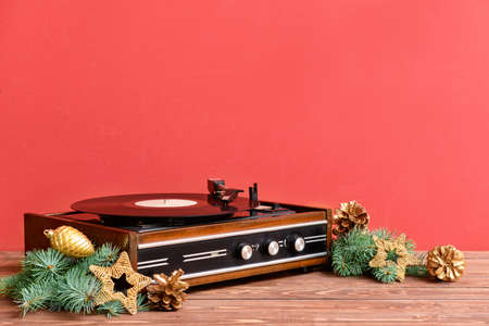 Retro player with Christmas decor on wooden tableの写真素材