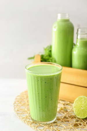 Glass of healthy smoothie on white tableの写真素材