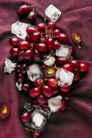 Tasty sweet grapes with ice cubes on napkinの写真素材