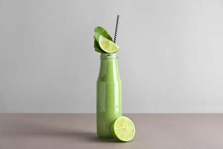 Bottle of tasty smoothie on gray backgroundの写真素材