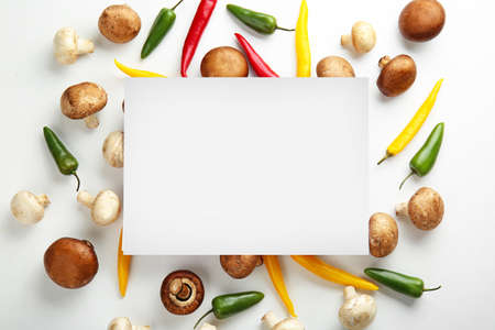 Fresh vegetables and blank card on white backgroundの写真素材
