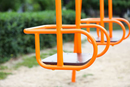 Swings on playground in parkの写真素材