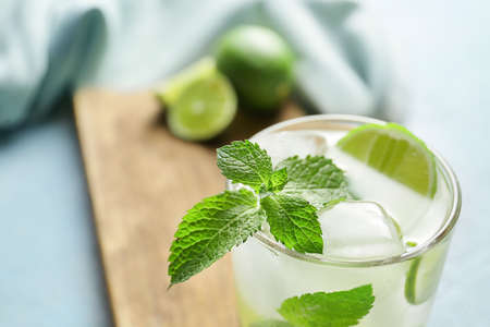 Glass of fresh mojito on table, closeup