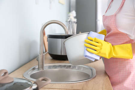 Woman washing modern multi cooker in kitchenの写真素材