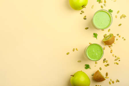 Glasses of tasty green smoothie on light backgroundの写真素材