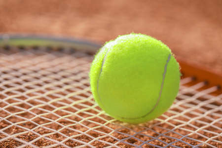 Tennis ball on racket, closeupの写真素材