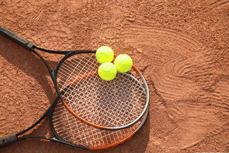 Tennis balls and rackets on courtの写真素材