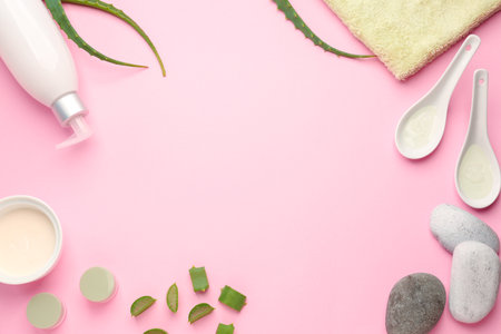 Cosmetic products with aloe leaves and spa stones on color backgroundの写真素材