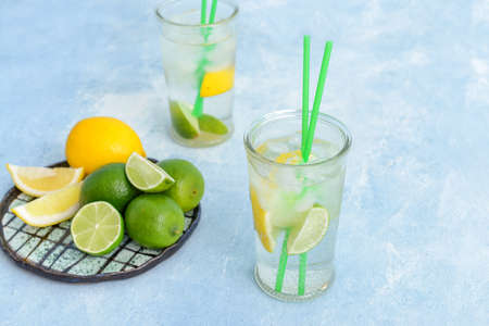 Glasses of fresh infused water with citrus fruits on tableの写真素材
