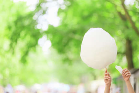 Female hands with sweet cotton candy outdoorsの写真素材