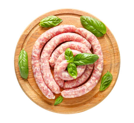 Wooden board with fresh raw sausages on white backgroundの写真素材