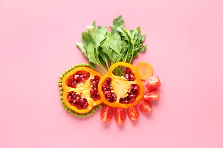 Fresh vegetables with pomegranate seeds and arugula on color backgroundの写真素材
