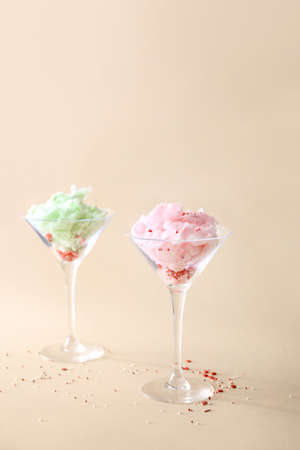 Glasses with tasty cotton candy on color backgroundの写真素材