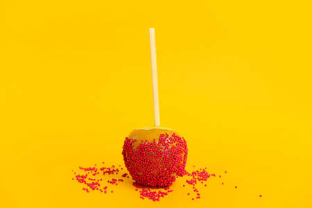Tasty candy apple on color backgroundの写真素材