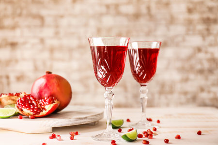 Glasses of tasty pomegranate juice on tableの写真素材