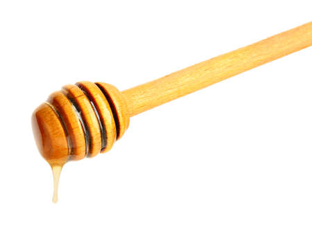 Wooden honey dipper on white backgroundの写真素材