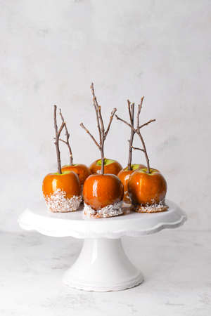 Dessert stand with tasty candy apples on tableの写真素材