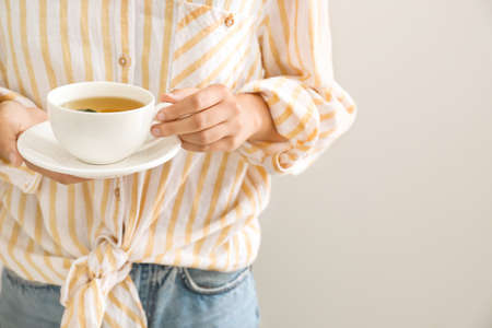 Woman holding cup of hot tea, closeupの写真素材
