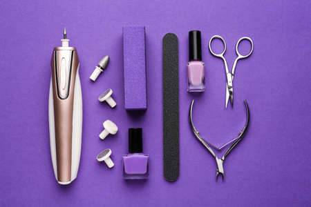 Supplies for manicure and pedicure on color background
