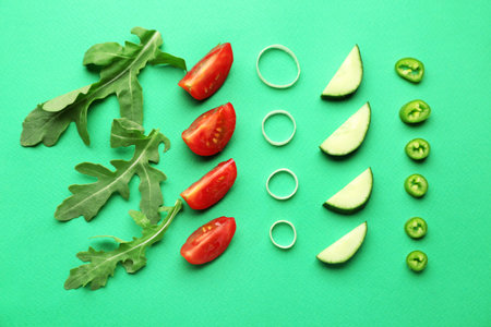 Fresh arugula with vegetables on color backgroundの写真素材